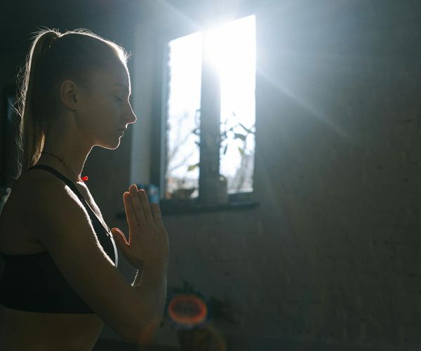 Serene woman sitting in meditation focusing on inner strength
